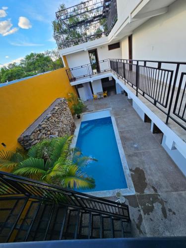 a swimming pool on the balcony of a building at Hotel Victoria Queen Villavieja in Villavieja