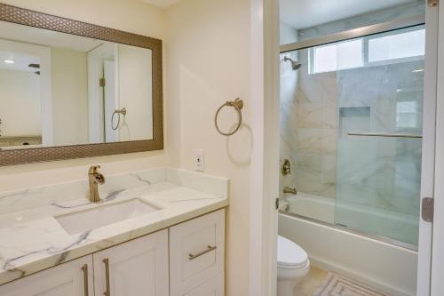 a bathroom with a sink and a toilet and a mirror at Ocean-View Oasis Steps to Dana Point Beaches! in Dana Point