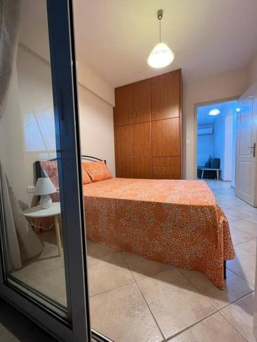 a bedroom with a bed and a table and a mirror at Demi ΔΣ, B2 in Agrinio