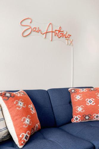 a sign on the wall above a blue couch at Private Heated Pool & Hot Tub, 4BR Gameroom in San Antonio
