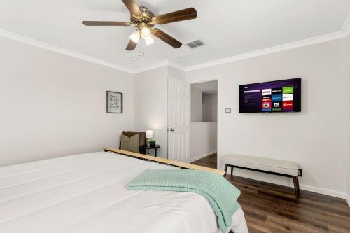 a bedroom with a bed and a ceiling fan at Private Heated Pool & Hot Tub, 4BR Gameroom in San Antonio