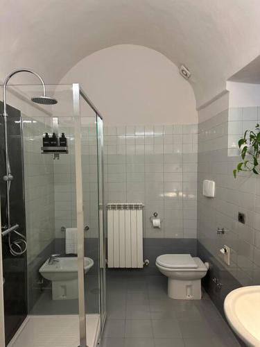 a bathroom with a shower and a toilet and a sink at I Tre Re, arte e storia. in Fossombrone