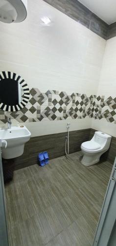 a bathroom with a sink and a toilet and a mirror at كيان ( KAYAN) in Sūr ash Shiyādī