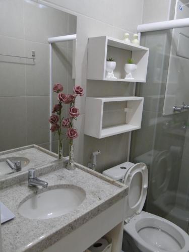a bathroom with a sink and a toilet at SUNNY HALL in Porto De Galinhas