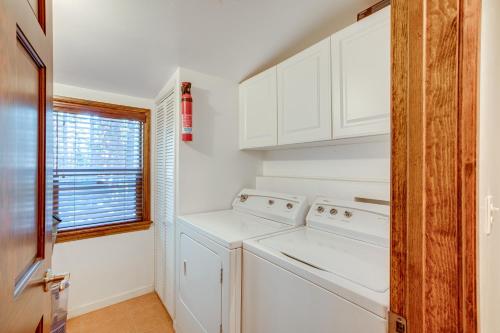 a kitchen with white cabinets and a washer and dryer at Serene South Lake Tahoe Getaway with Spacious Deck! in South Lake Tahoe