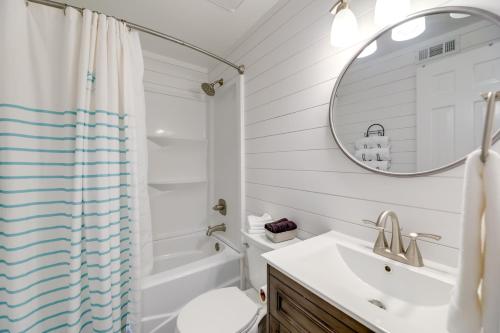 a white bathroom with a sink and a mirror at Emerald Isle Vacation Rental, Walk to Beach! in Emerald Isle