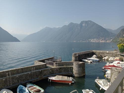 a group of boats docked at a dock on a lake at Casa Corinna, Lake View, Terrace, Private Garage! in Colonno