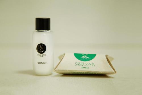 a bottle of sunscreen next to a bottle of soap at Hotel Santa Sofia in Puerto Salgar