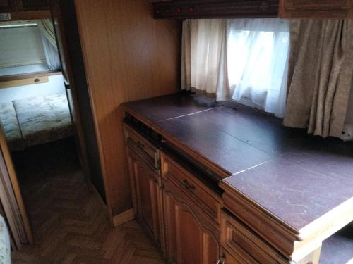 a wooden cabinet in a room with a window at Finca rústica cerca playa todas las comodidades in Bueu