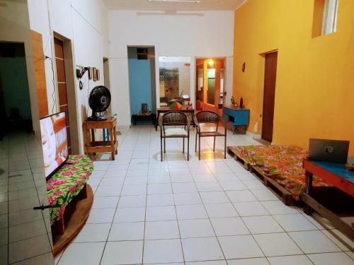 una sala de estar con mesas y sillas. en Lê'Frevo Pernambucano Hostel en Recife