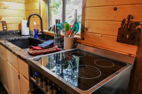 a kitchen with a sink and a stove top oven at Nicky's Resort in Estes Park