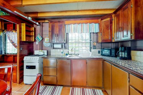 a kitchen with wooden cabinets and a sink and a stove at Ocean Edge Gold Standard Certified in Maya Beach