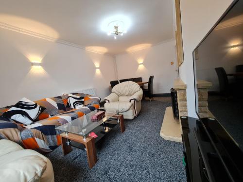 a living room with two couches and a fireplace at Bristol 2-Bed Bungalow Sleeps 4 Parking in Bristol