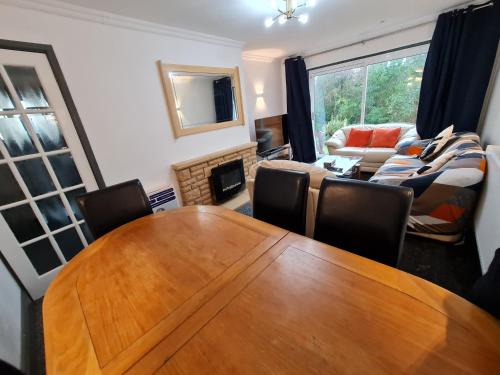 a living room with a wooden table and chairs at Bristol 2-Bed Bungalow Sleeps 4 Parking in Bristol