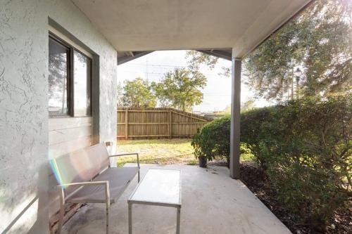 a bench sitting on the porch of a house at Cute downtown home by Depot Park in Gainesville