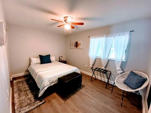 a bedroom with a bed and a ceiling fan at Cute downtown home by Depot Park in Gainesville