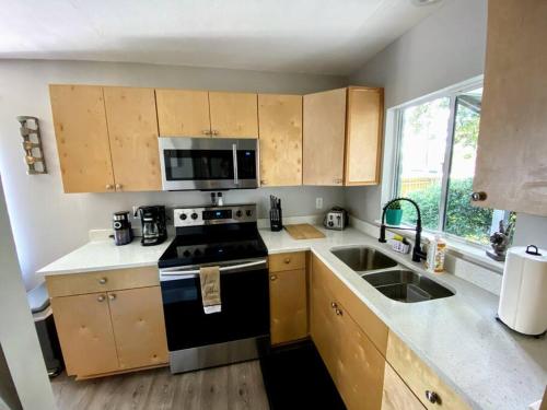 a kitchen with a black stove and a sink at Cute downtown home by Depot Park in Gainesville