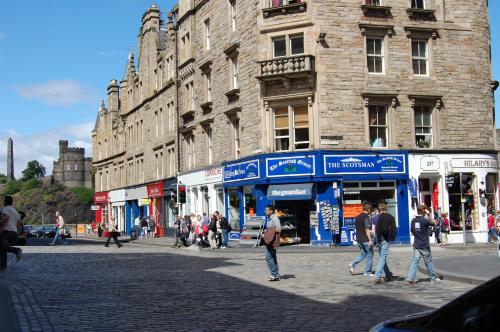 a group of people walking on a city street at Royal Mile Cranston in Edinburgh