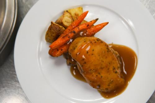 a plate of food with meat and carrots and gravy at Sheraton Tucson Hotel & Suites in Tucson