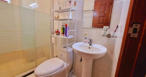 a bathroom with a toilet and a sink at Rossyln Home close to Village Market, UN and Two Rivers Mall in Nairobi