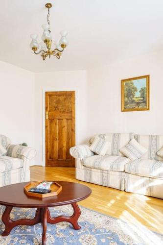 a living room with a table and a couch at Wembley Arch View, 4-Bed House, Drive for 2 cars in London