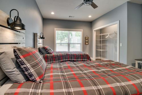 a bedroom with a bed and a ceiling fan at Modern Norfork River Cabin Rental with Shared Dock! in Norfork