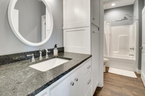 a bathroom with a sink and a toilet and a mirror at Modern Norfork River Cabin Rental with Shared Dock! in Norfork
