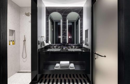 a bathroom with a sink and a mirror at Daxton Hotel in Birmingham