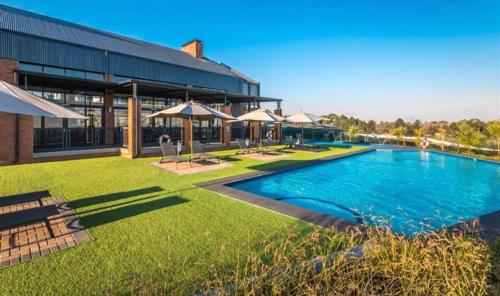 a large swimming pool in front of a building at Offline in Boksburg