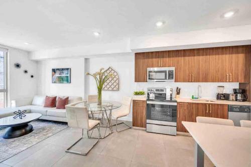 a kitchen and living room with a table and a couch at Modern Unit in Downtown Miami With Free Parking in Miami