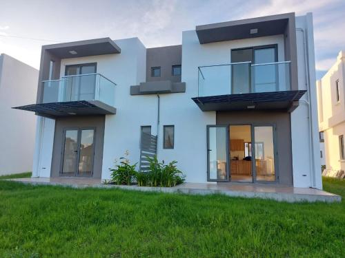 a house with two balconies on the side of it at Blissful Abode GV in Grand Gaube