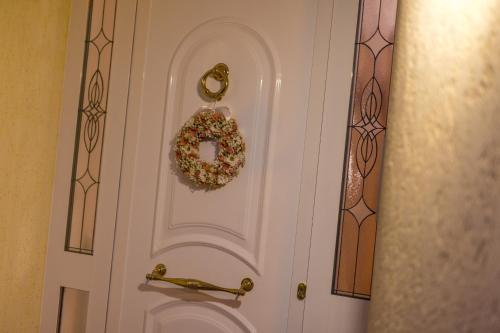a white door with a wreath on it at Apartment Punat in Punat