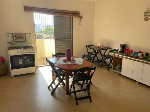 a kitchen with a table and chairs in a room at Hostel Salus in Barueri