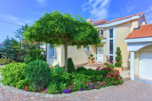 a house with a tree in the front yard at Apartment Punat in Punat