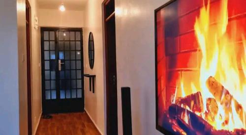 a hallway with a tv and a door with a fireplace at Rossyln Home close to Village Market, UN and Two Rivers Mall in Nairobi