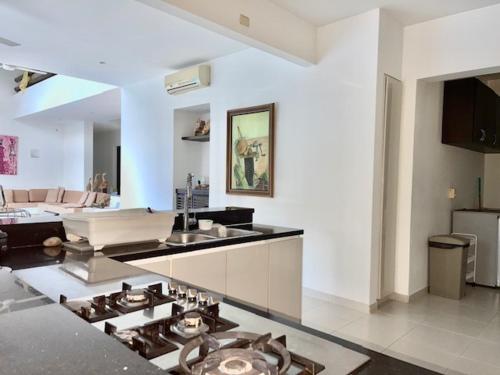 a kitchen with a stove top oven in a living room at Casa HESTIA Condominio Campestre el Peñon Girardot in Girardot