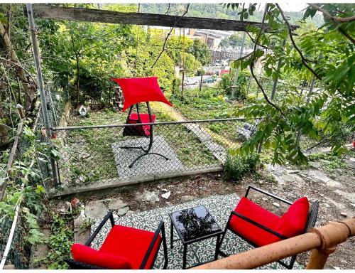 a patio with red chairs and a table at 4-A Diamond in Yonkers in Yonkers