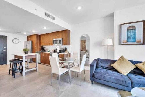 a living room with a blue couch and a kitchen at Wonderful Unit In Downtown Miami With Free Parking in Miami