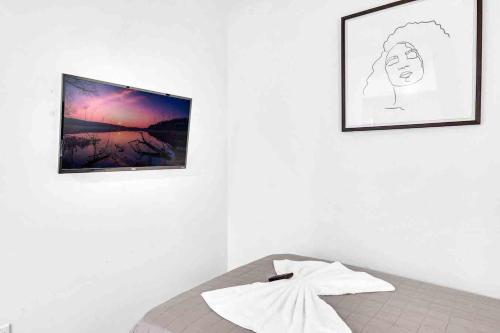 a bedroom with two pictures on the wall and a bed at Wonderful Unit In Downtown Miami With Free Parking in Miami