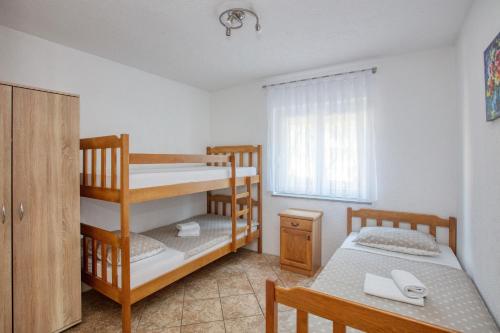 een slaapkamer met twee stapelbedden en een tafel bij Apartments with parking space Jezera, Murter - 5133 in Jezera