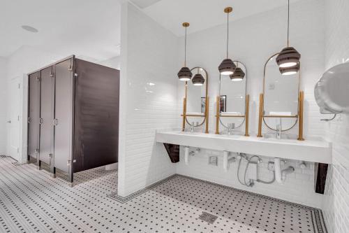 a bathroom with two sinks and two mirrors at Wonderful Unit In Downtown Miami With Free Parking in Miami