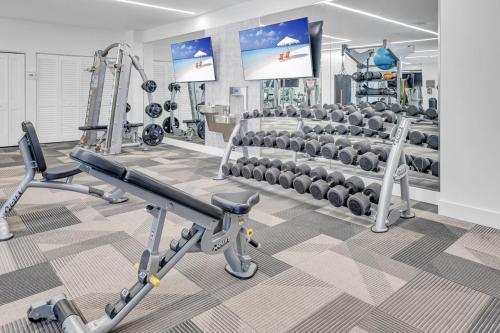 a gym with several treadmills and machines at Wonderful Unit In Downtown Miami With Free Parking in Miami