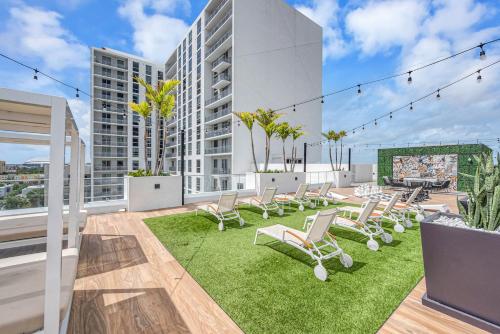 a patio with chairs and grass on a building at Wonderful Unit In Downtown Miami With Free Parking in Miami