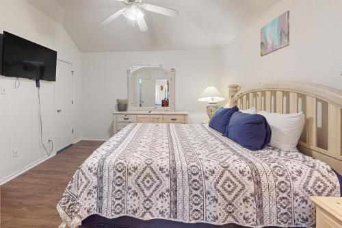 a bedroom with a bed and a ceiling fan at Brickside Beauty in Killeen