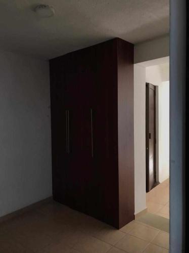 a dark colored cabinet in a room with a hallway at San Fernando Hostal in Oaxaca City