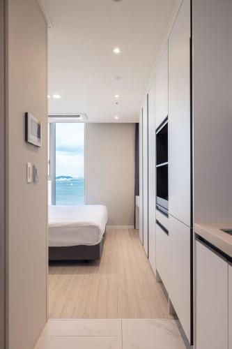 a bedroom with a bed and a view of the ocean at OCEAN PARK 9 in Incheon