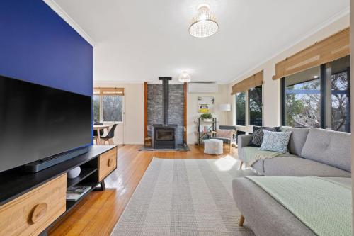 a living room with a large flat screen tv at Back Beach Oasis in Smiths Beach