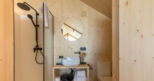 a bathroom with a sink and a mirror on a wall at Doniños Nature in A Coruña