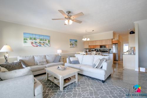 a living room with two couches and a table at Beachfront Oasis At Tybee Island in Tybee Island