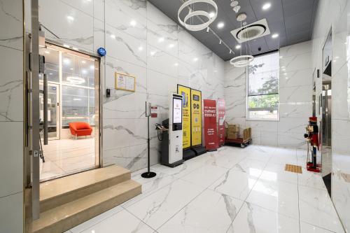 a lobby of a store with a red chair and stairs at GL City Hotel Incheon Airport in Incheon